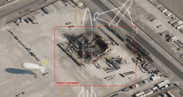 Satellite view of a destroyed aerostat support facility at a military base, with a tethered aerostat visible nearby