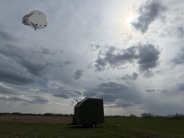 AB12TC aerostat complex in flight with trailer, overcast sky